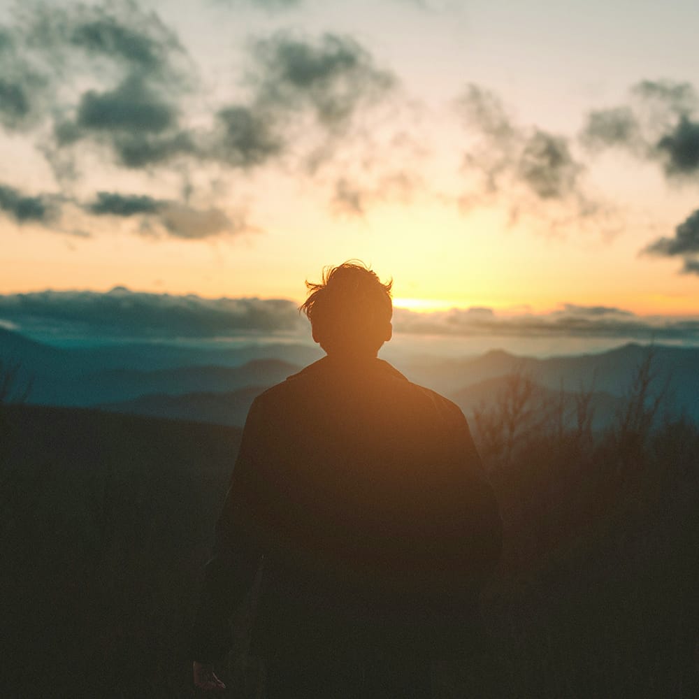 Man watching the sun rise